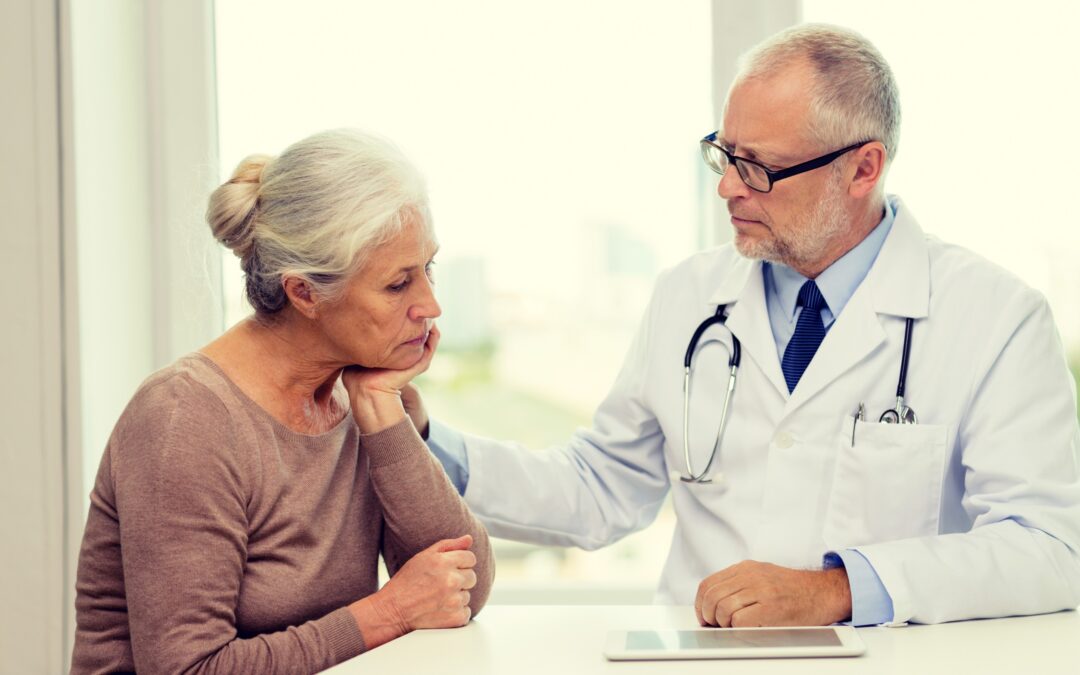 A doctor talking to a senior patient